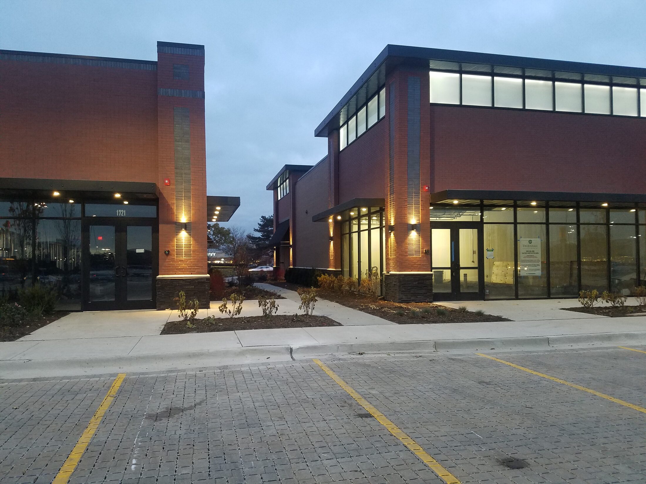 Retail center exterior lighting at dusk