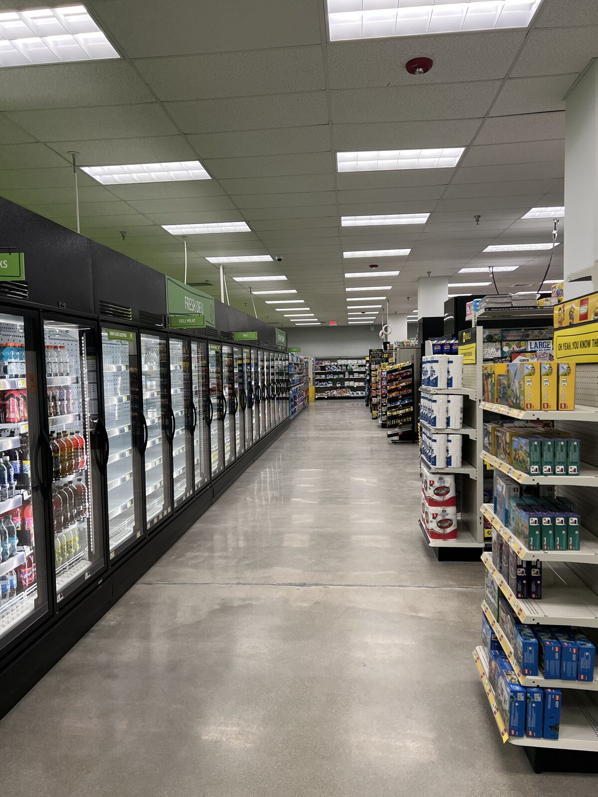 Grocery store cooler aisle with commercial lighting and refrigeration power